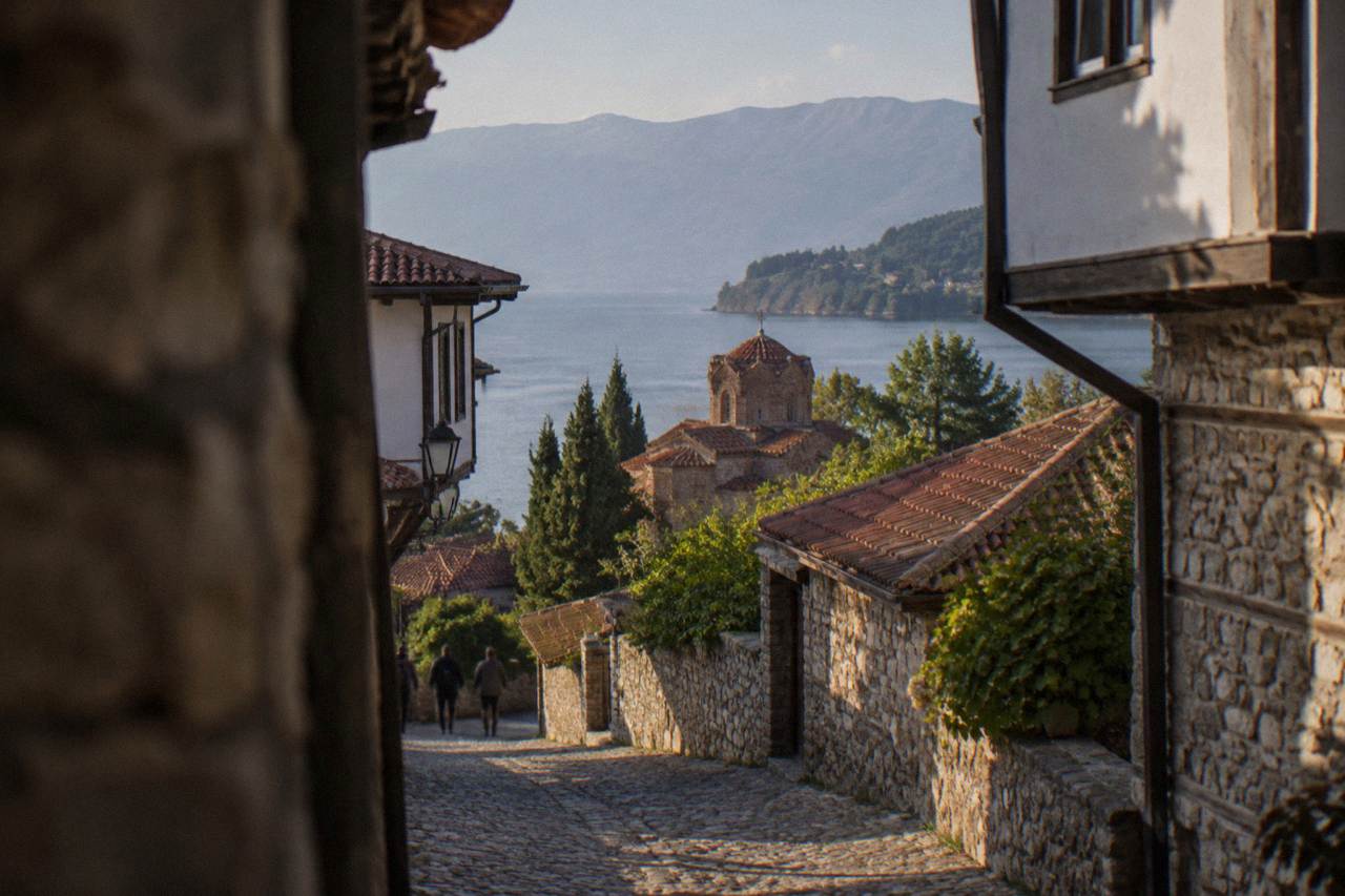 The shoreline of Lake Ohrid with wooded hills rising above the water