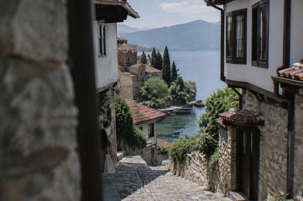 Wooden boats moored on the edge of Lake Ohrid below the old town of Ohrid