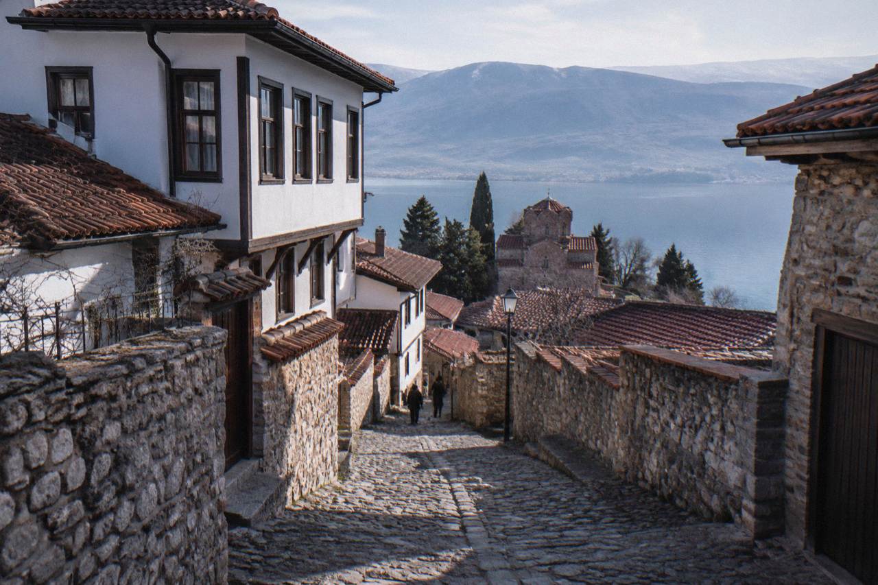 A road winding through mountains toward the town of Ohrid on the shore of Lake Ohrid