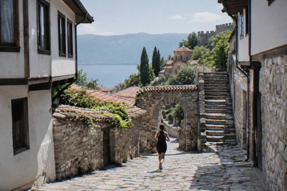 A stone gate and worn steps leading up through the old town toward the fortress hill in Ohrid