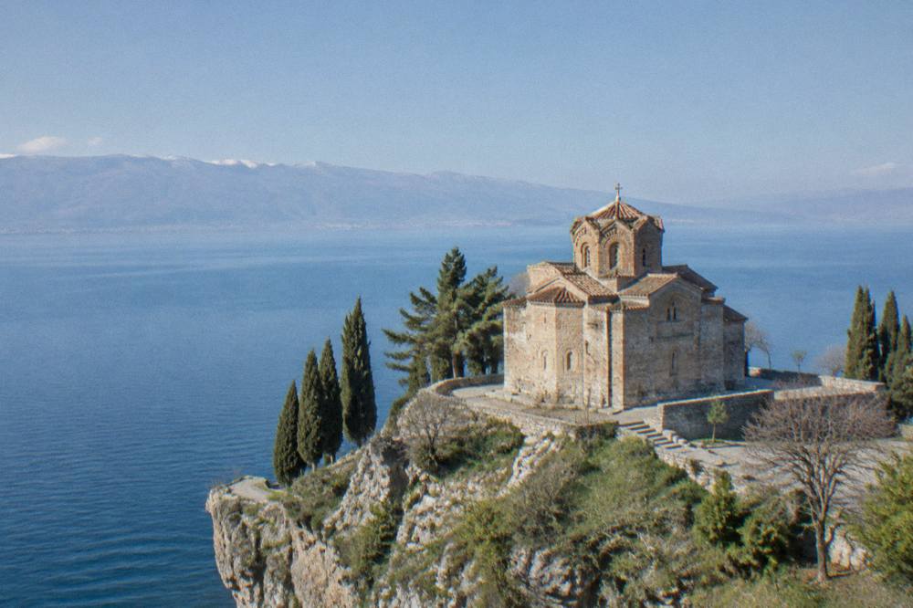 The Church of St John at Kaneo on its cliff above the blue water of Lake Ohrid.