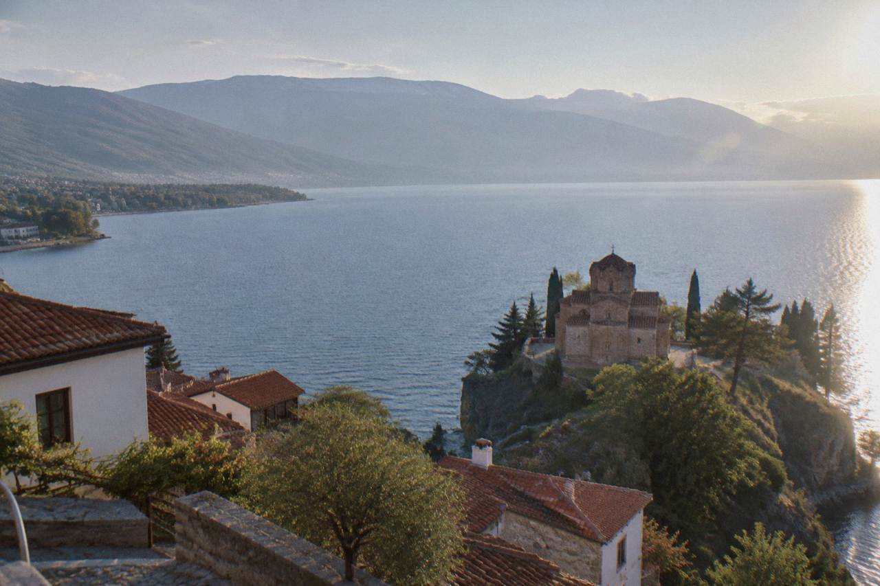 A wide view of Lake Ohrid from the old town of Ohrid with the Church of St John at Kaneo above the shoreline