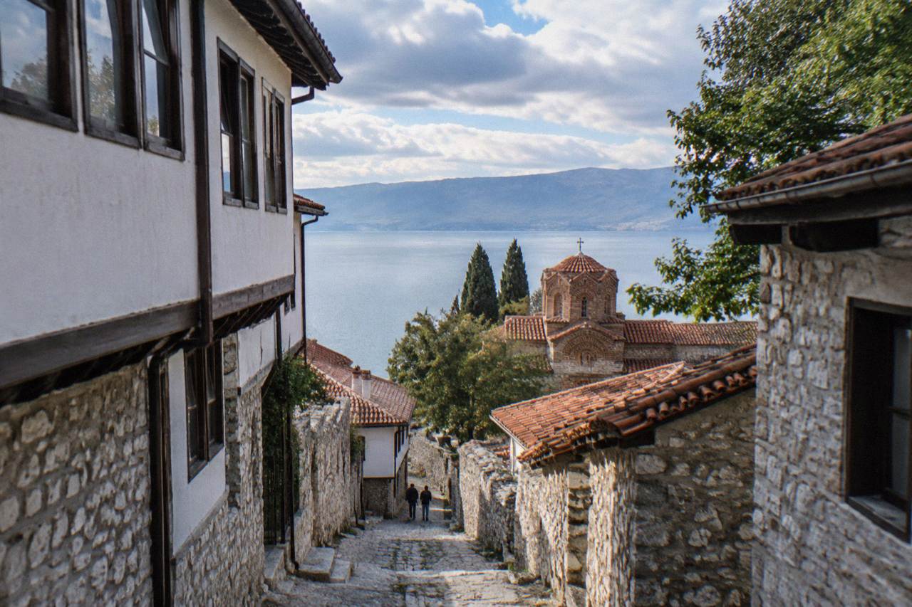 Stone lanes and old church walls above the rooftops of Ohrid's old town