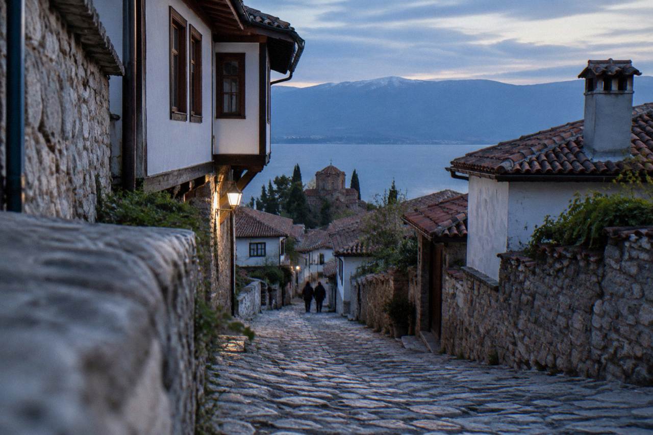The old town of Ohrid rising above the red rooftops toward the hills above Lake Ohrid
