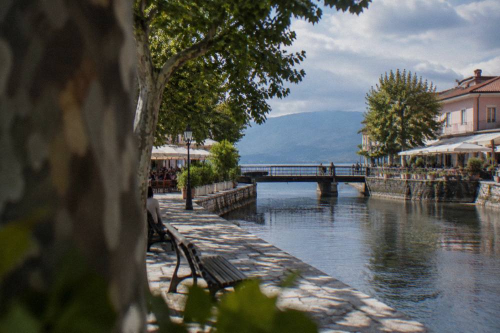 The Black Drim river flowing through Struga beside a low bridge