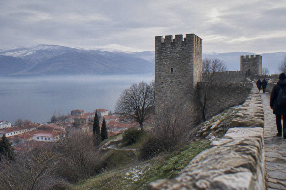 The stone walls of Samuel's Fortress above Ohrid with Lake Ohrid and bare winter hills in the distance