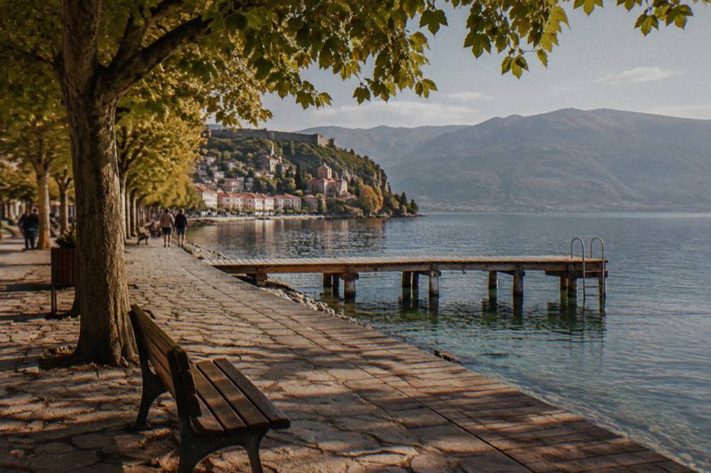 A wooden jetty over clear green water at a swimming spot on Lake Ohrid