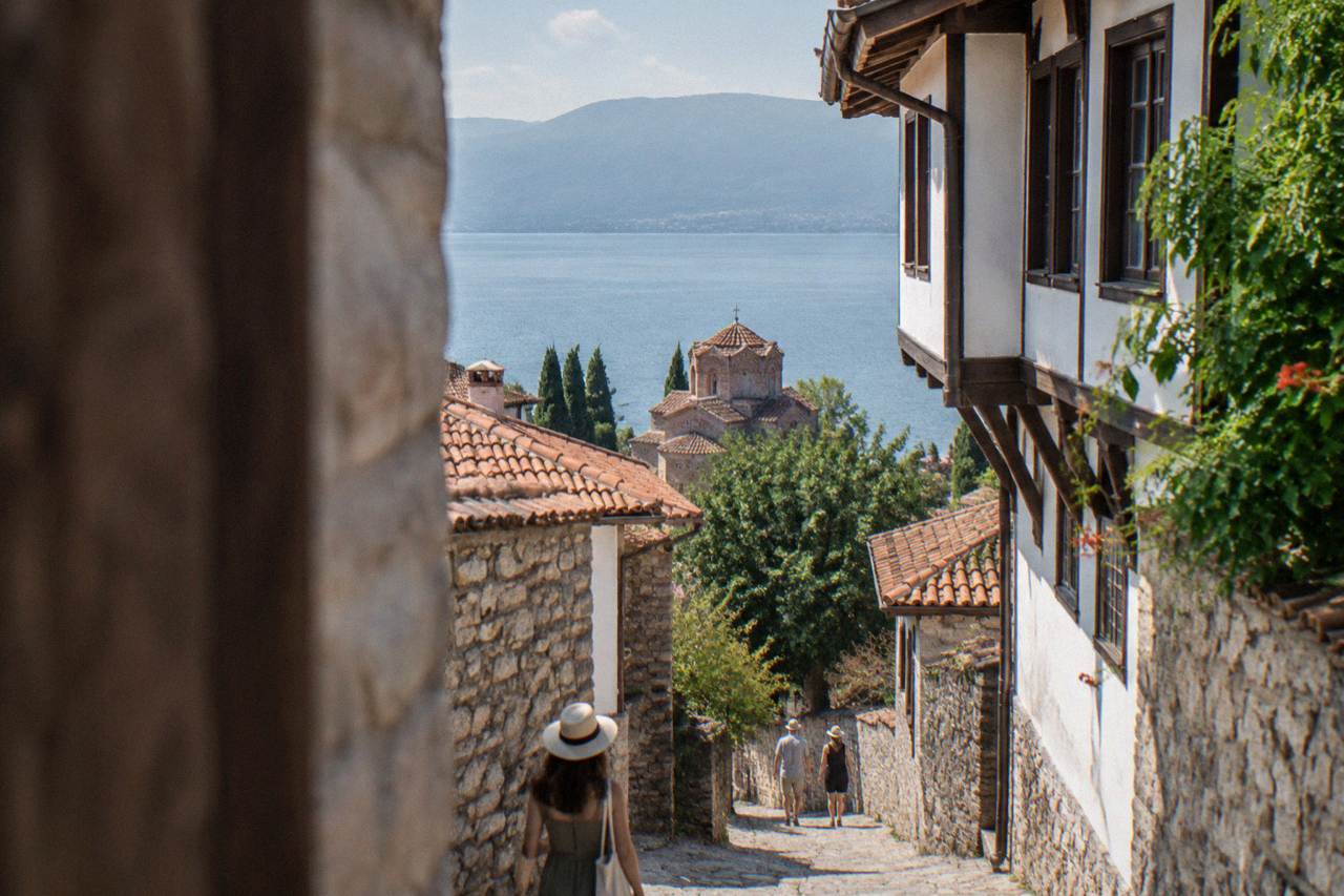 Open-air stone theatre seating above the rooftops of Ohrid old town and Lake Ohrid