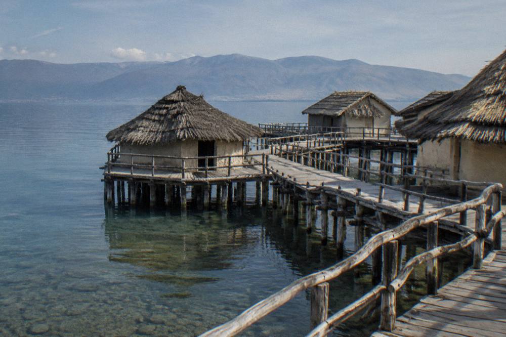 Wooden walkways of the Bay of Bones pile-dwelling museum above the water on Lake Ohrid
