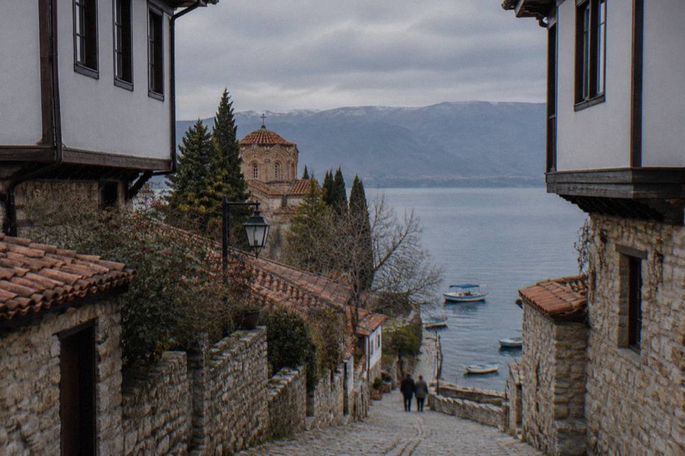 Fishing boats moored on Lake Ohrid beside the old town promenade in soft evening light