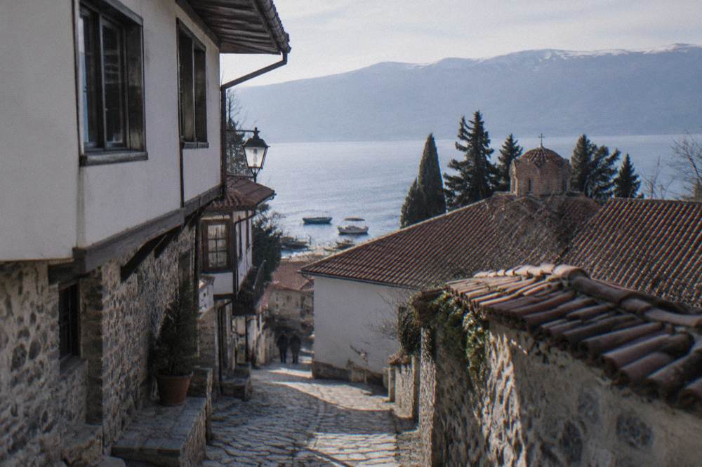 Boats moored at the Ohrid port below the old town hillside