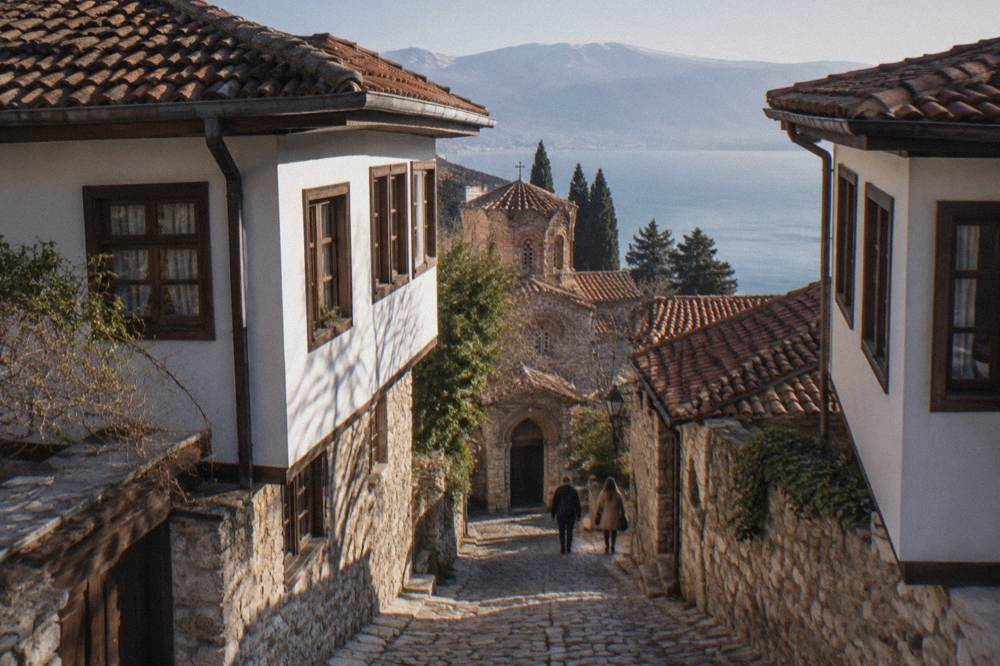 Narrow stone lane in Ohrid old town leading towards a church doorway