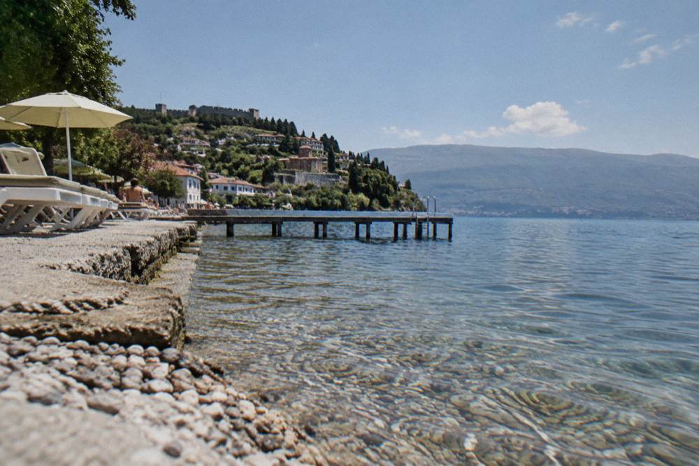 Clear water over smooth pebbles at the edge of a mountain lake
