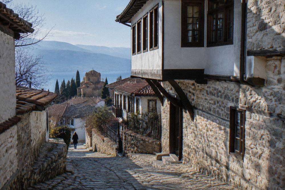 A narrow stone lane climbing between old houses in the upper old town of Ohrid