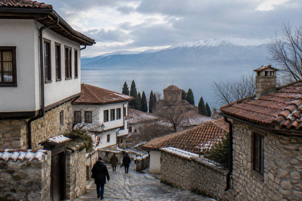 Snow-dusted hills above Lake Ohrid seen across the water in winter