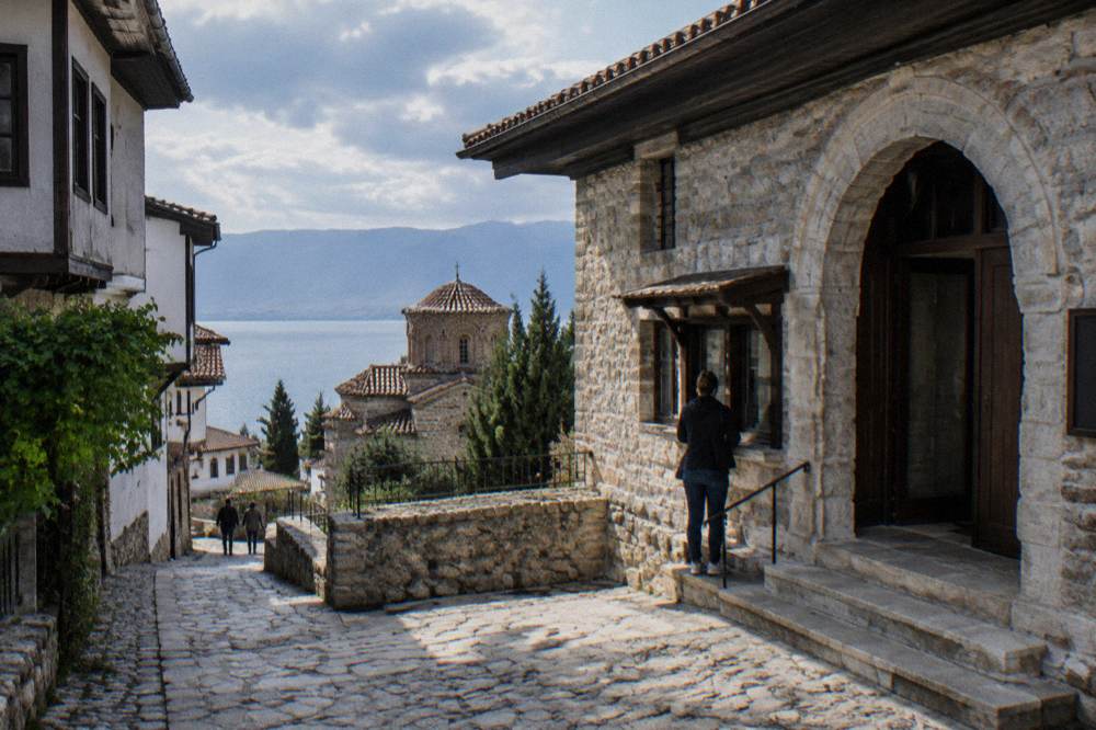 A ticket desk and stone entrance of a museum building in Ohrid