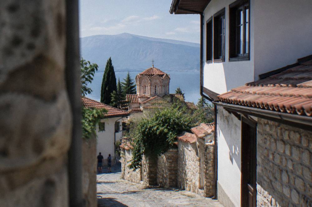 The white walls and terracotta roof of a Byzantine church above Lake Ohrid