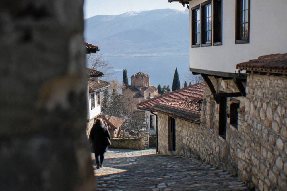 A sunny day over red rooftops and the blue water of Lake Ohrid