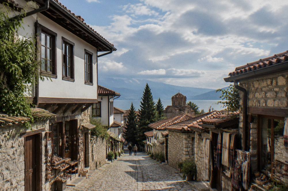 A narrow cobbled lane in Ohrid old town with small shopfronts on both sides