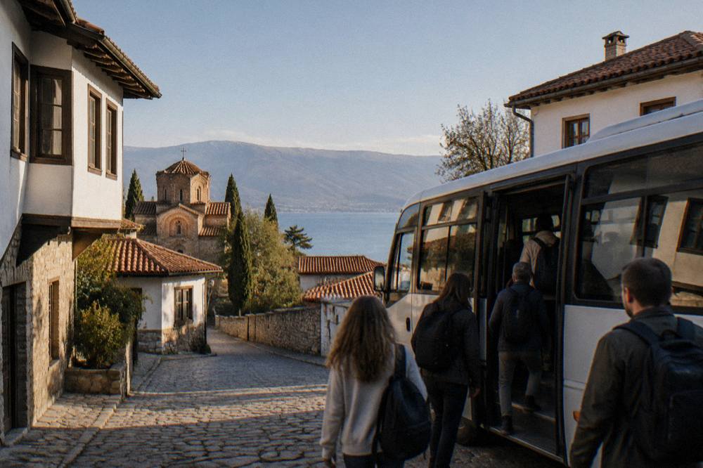 Passengers boarding a small bus at an Ohrid street terminal in morning light