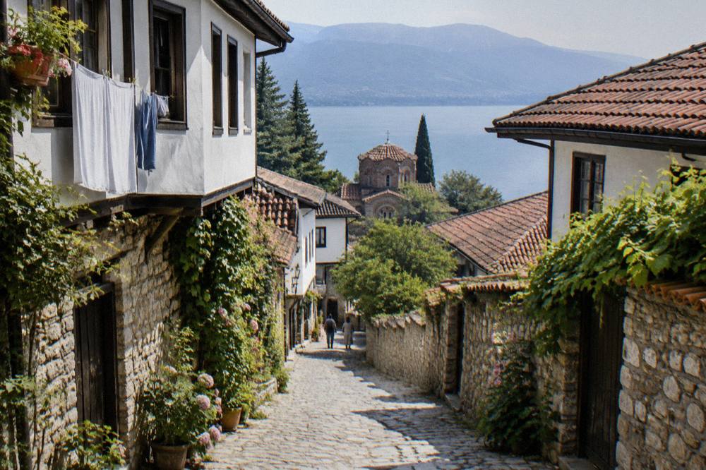 Sunlight on a stone lane in Ohrid old town with washing and plants on the walls