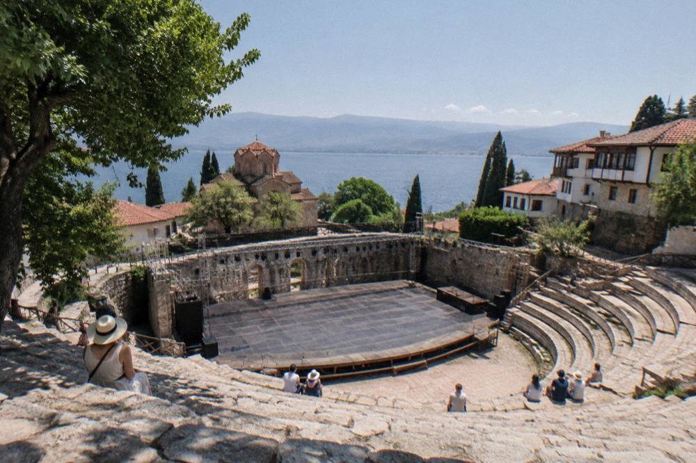 An open-air stone theatre stage prepared for an evening performance in Ohrid