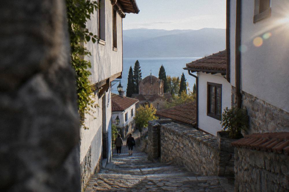 A worn stone stairway between whitewashed houses in Ohrid's Old Town