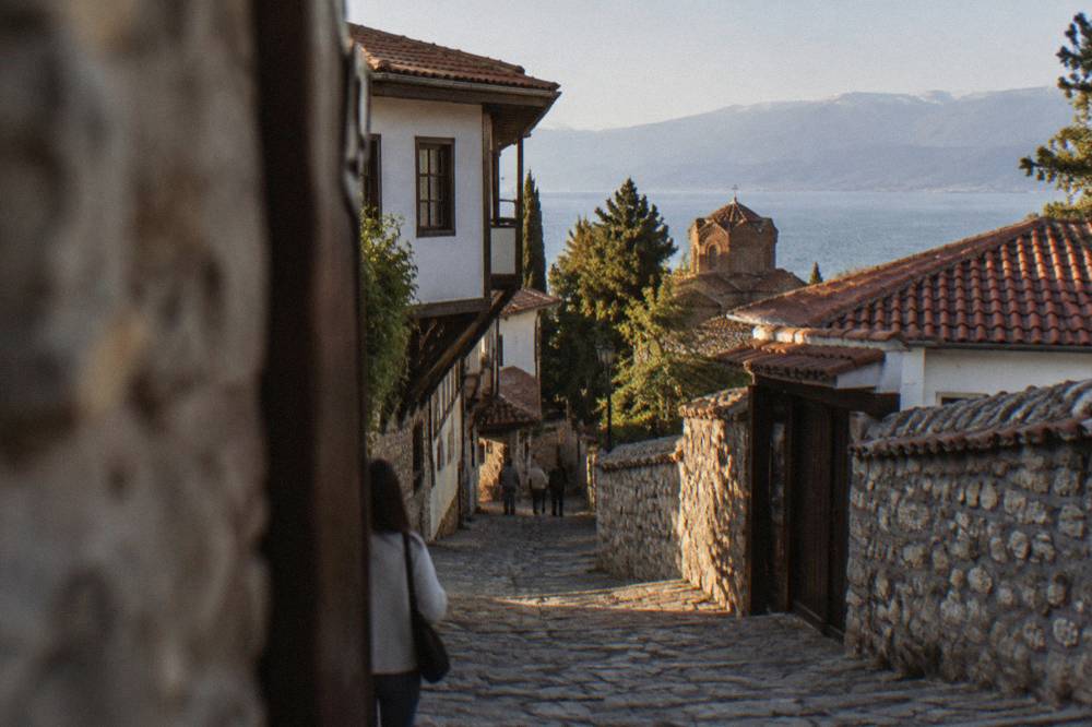 Narrow stone lane climbing through Ohrid's old town toward the fortress