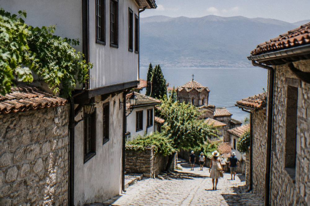 Lake Ohrid shoreline with clear water and hills beyond in summer light