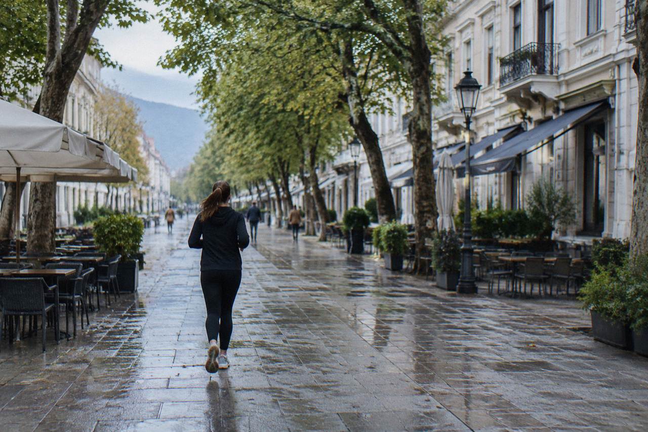 A long pedestrian street of pale neoclassical townhouses with cafe terraces and plane trees in Bitola