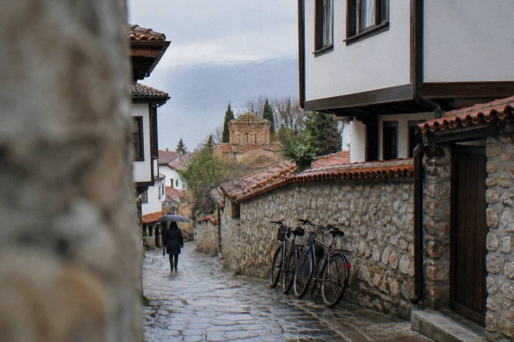 Bicycles leaning against a wall in a narrow Ohrid old town street
