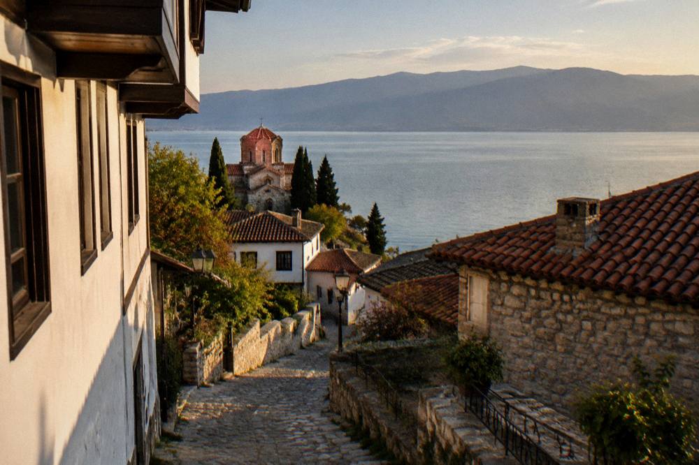 Evening light over the calm surface of Lake Ohrid seen from the shore path