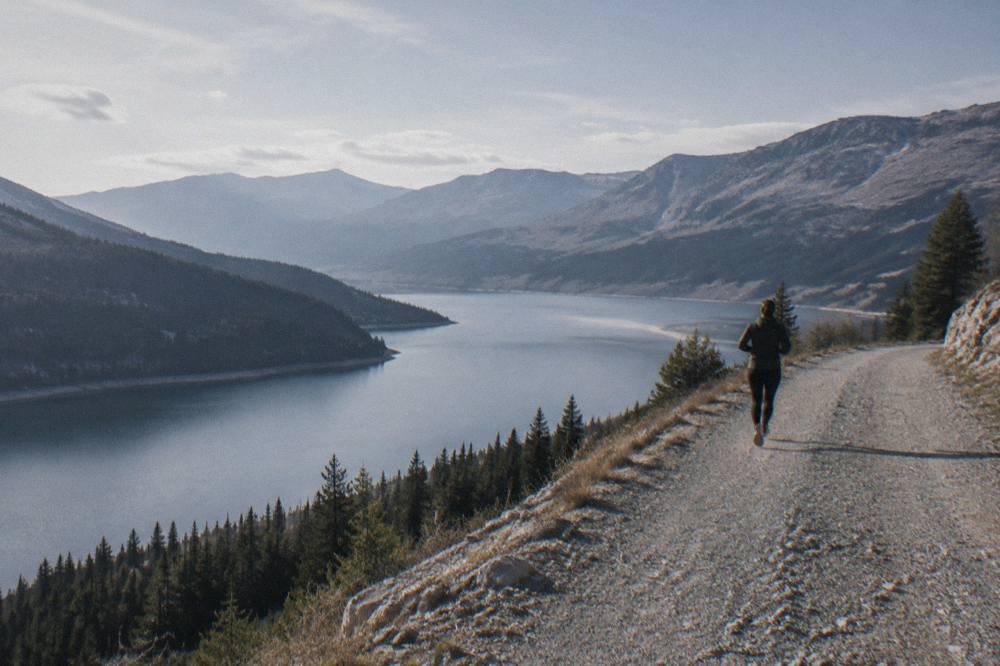 A wide mountain reservoir seen from a high roadside viewpoint