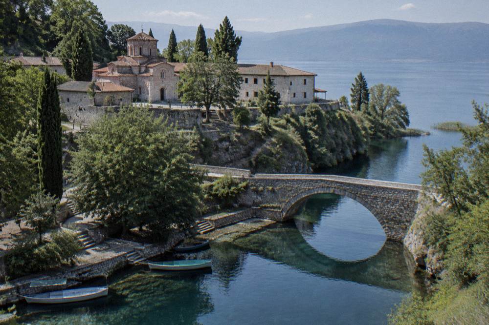 A stone bridge over the Crn Drim in Struga with reflections in the still water