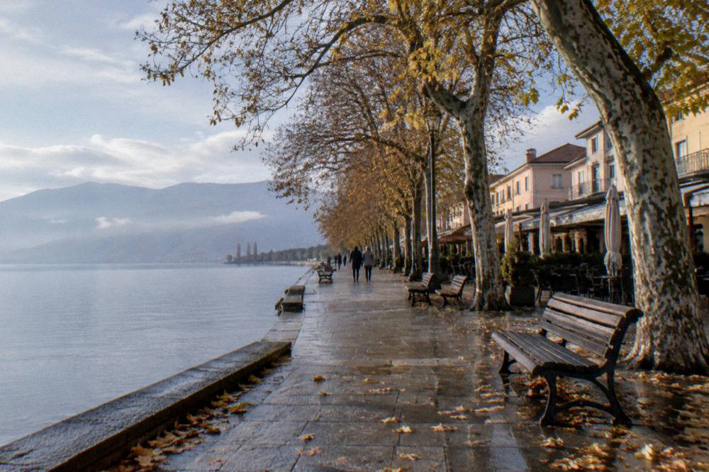 The Struga lake shore in autumn with calm grey water and bare trees