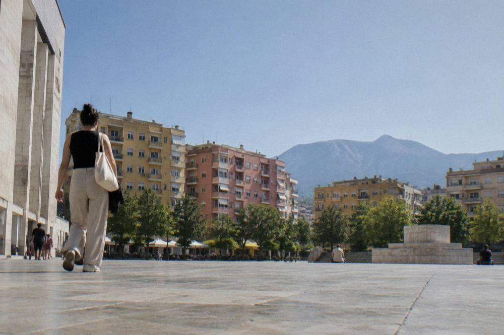 A terrace overlooking a wide lake with mountains on the far shore