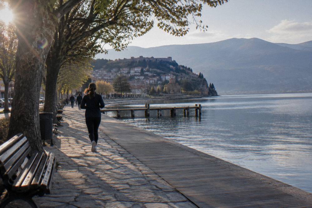 A river flowing through a small town beside a lakeside promenade