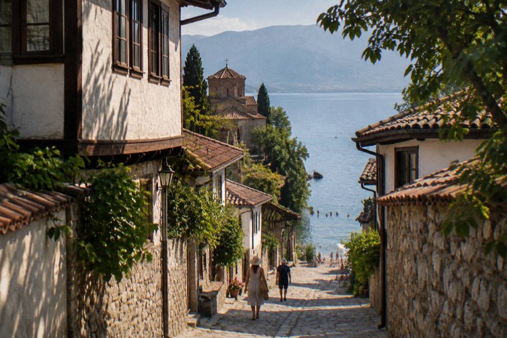 Swimmers and pebble beach along the shore of Lake Ohrid in summer