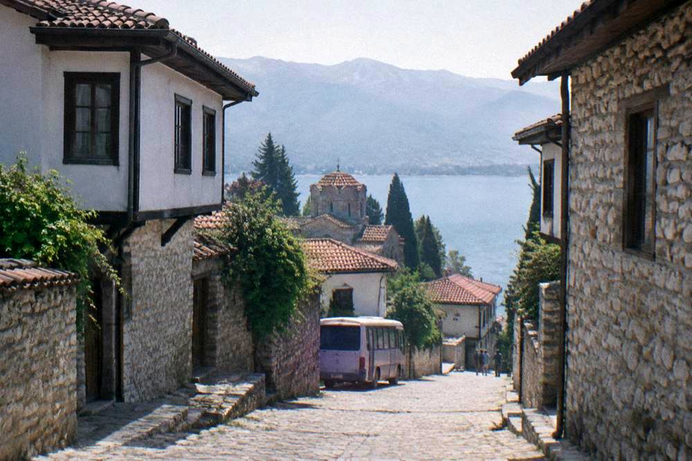 A small bus parked on a street in Ohrid near the lake shore
