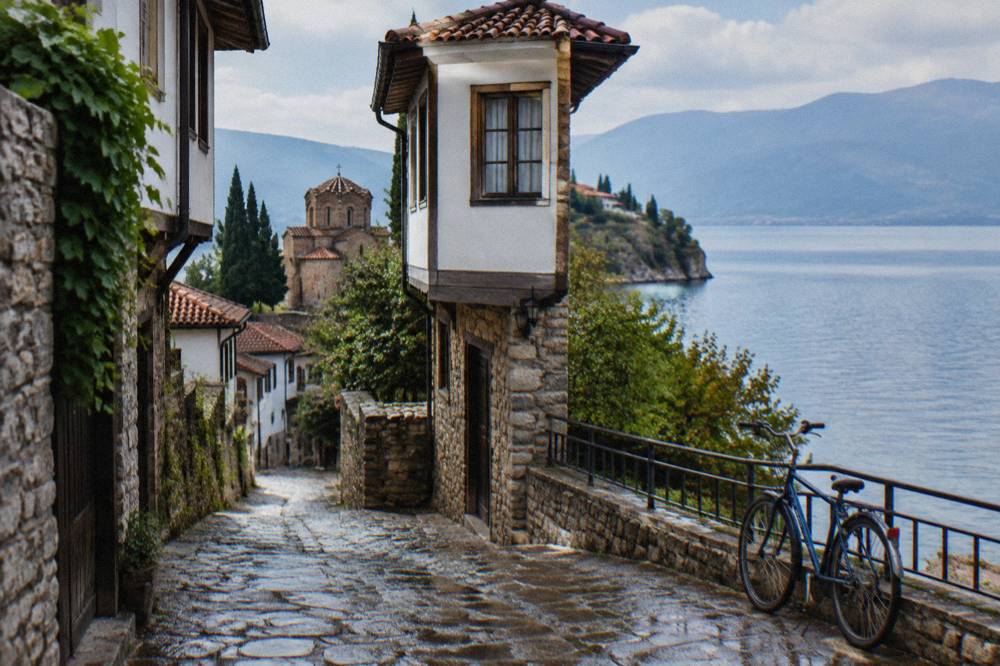 A lakeside road south of Ohrid with a bicycle leaning against a railing above the water