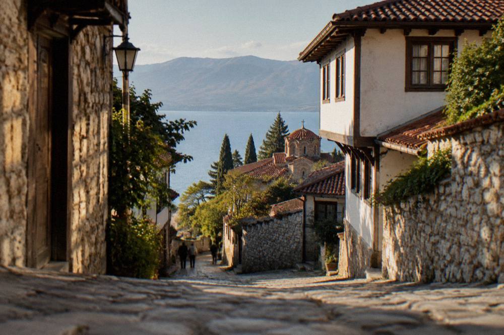 A map-style view of Lake Ohrid surrounded by mountains with the town on its shore