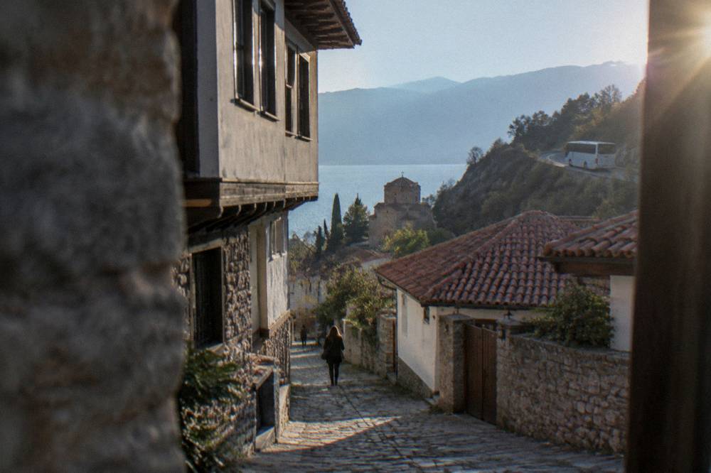 An intercity bus travelling on a road through mountains toward Ohrid