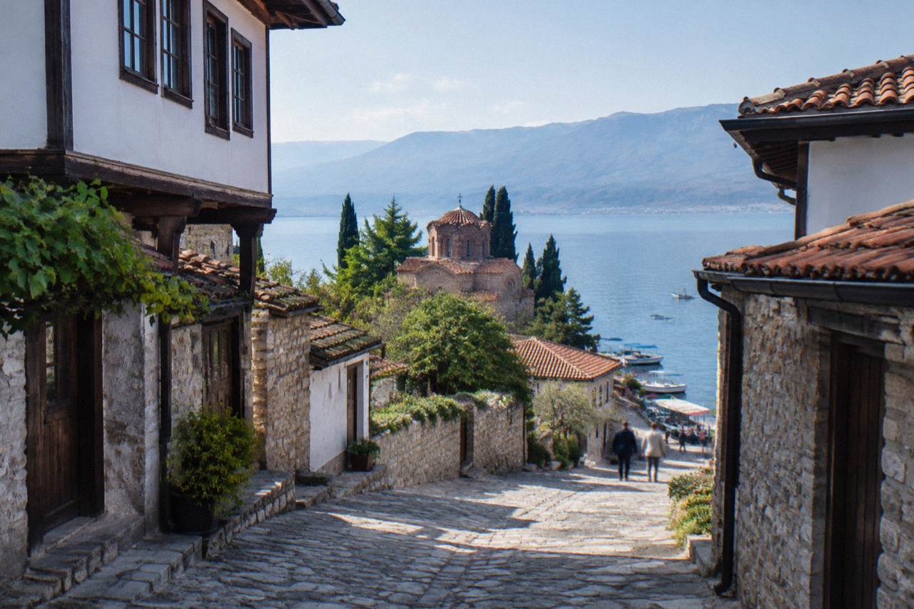 Small tour boats moored along the lakeside quay in Ohrid on a clear morning