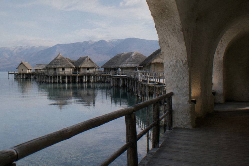 A wooden walkway over the water at the Bay of Bones pile dwelling museum