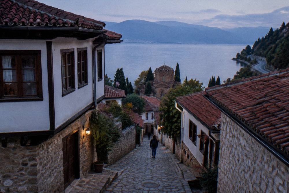 A quiet road winding along the forested east shore of Lake Ohrid