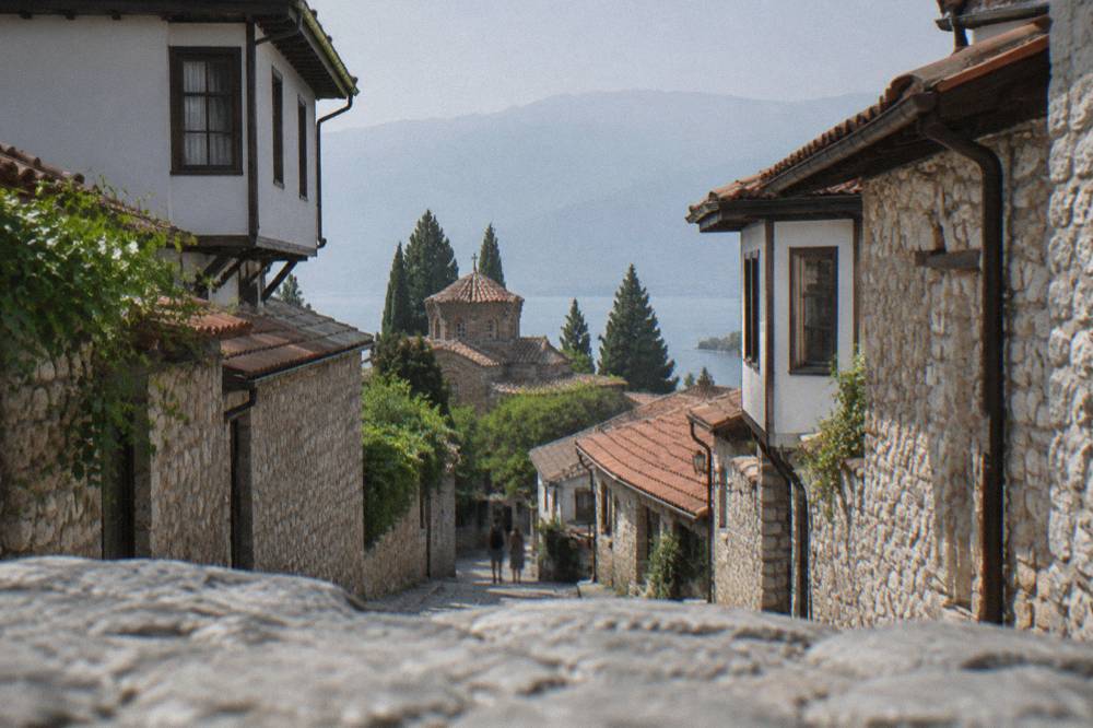 Small regional airport terminal building with a single aircraft parked on the apron
