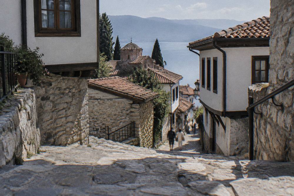 Worn stone steps connecting two levels of a narrow street in Ohrid