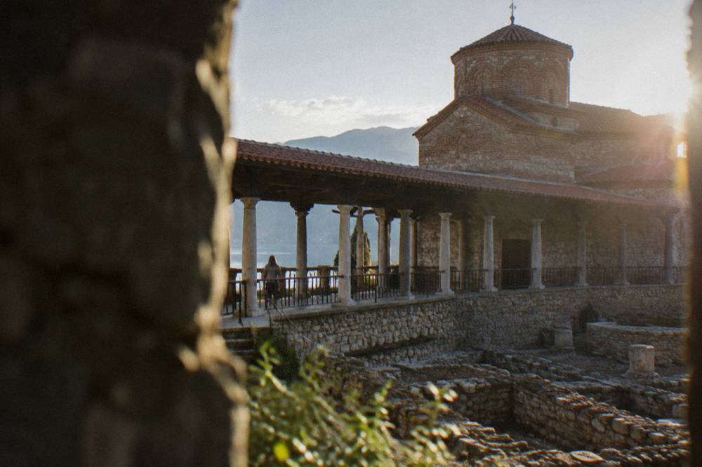 Reconstructed church with a long colonnaded terrace above an excavated archaeological site