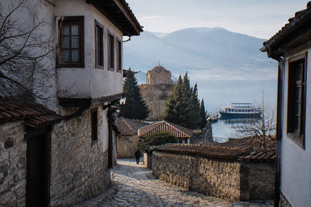 A small cruise boat moored at Ohrid port on a calm morning