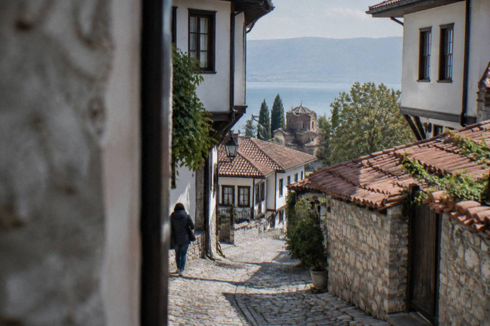 A visitor reading a museum display inside a traditional Ohrid house museum